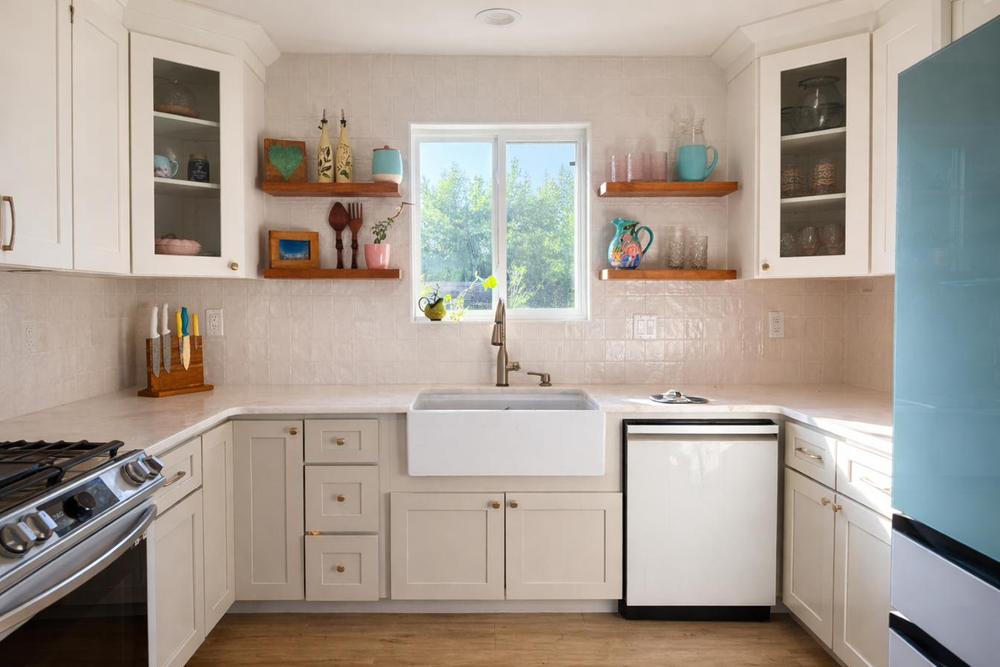 Farmhouse sink beneath the garden window, zellige-style tile