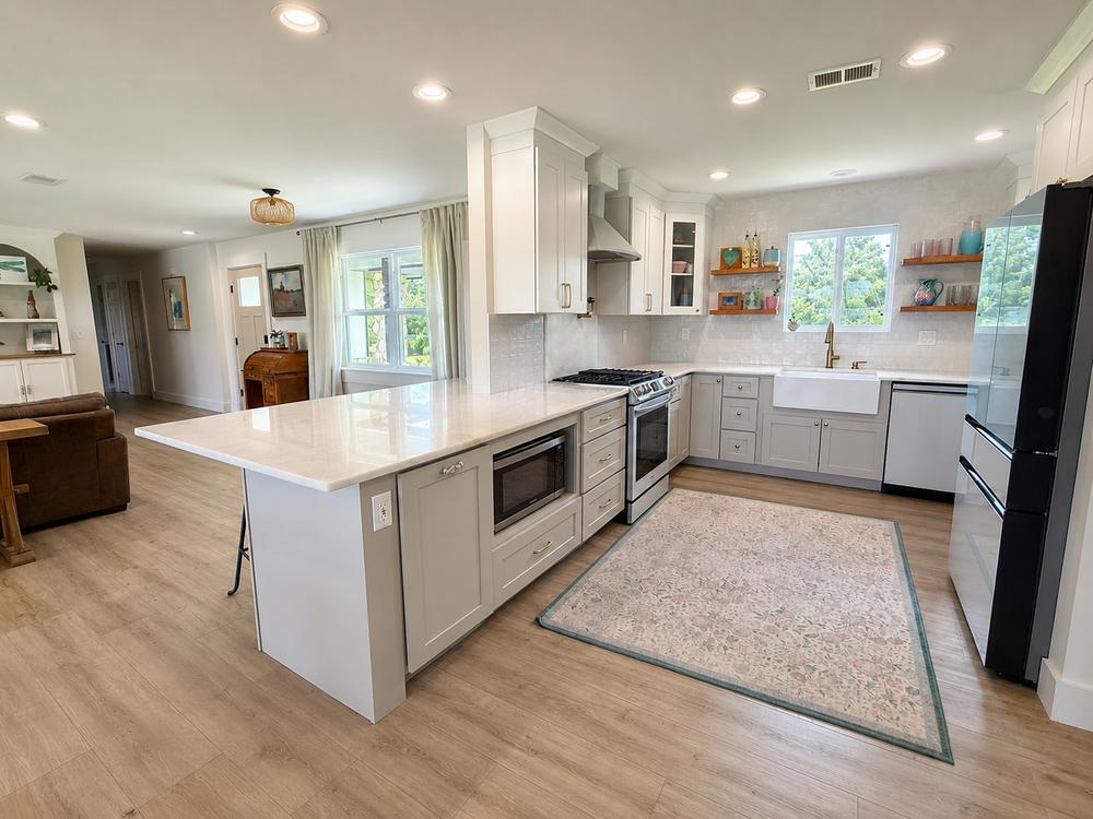 Full view of the kitchen, island, and open living flow
